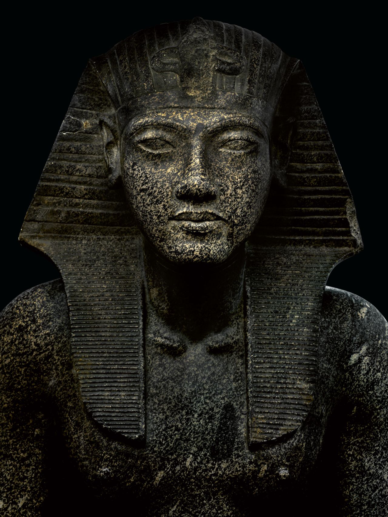 This photograph captures a statue depicting the young king in the nemes headdress.