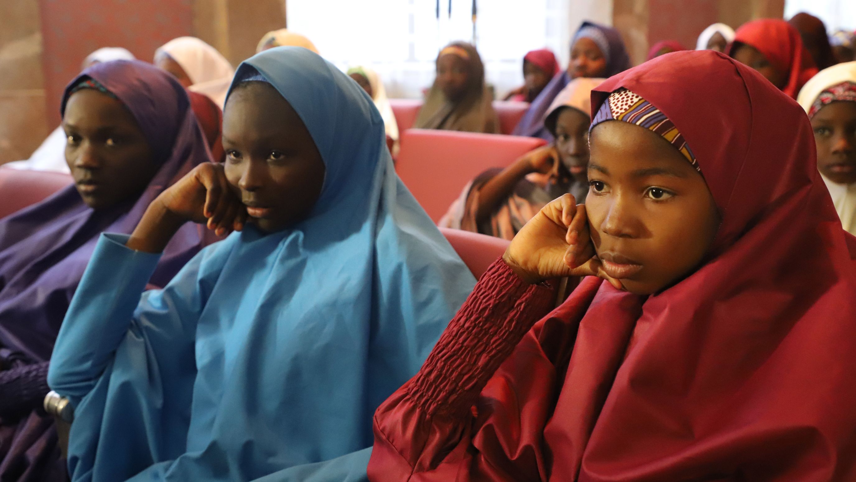 Some of the Dapchi schoolgirls released by Boko Haram sit before their meeting with the Nigerian President on Friday.