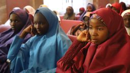 Released Nigerian school girls who were kidnapped by Boko Haram from their school in Dapchi, in the northeastern state of Yobe, sit at the Presidential Villa in Abuja before meeting with the president on March 23, 2018.