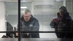 Officials from the Information Commissioner's Office (ICO) are seen looking at a computer inside the London headquarters of data firm Cambridge Analytica after a warrant was granted to search the property Friday, March 23, 2018. 