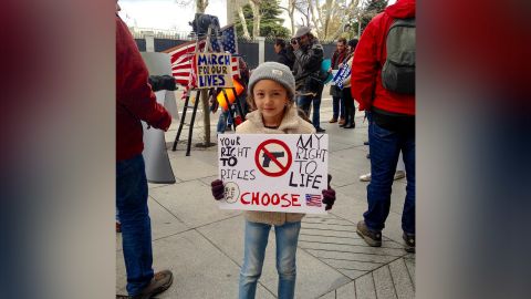 Lucia Smith, 6, gets an early introduction to activism by marching Saturday in Madrid.
