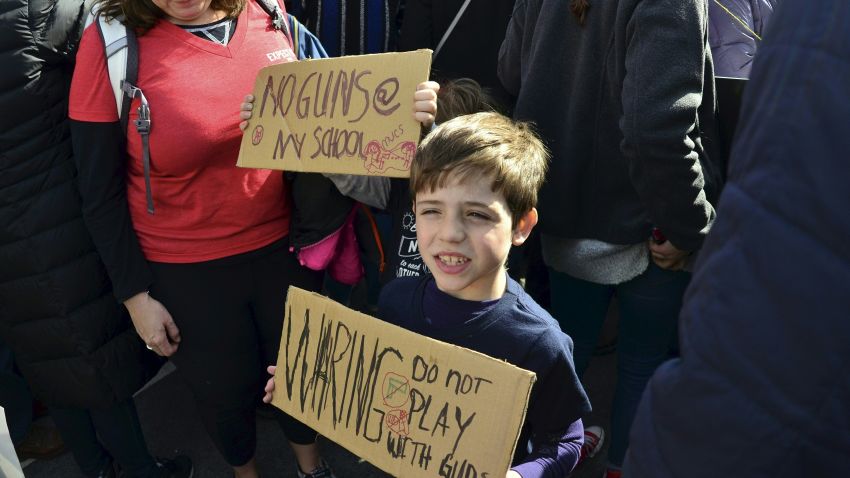 A boy displays a poster at the March for Our Lives rally in Washington, DC on March 24, 2018. Galvanized by the February 2018 gun massacre at a Florida high school, hundreds of thousands took to the streets in cities across the United States on Saturday in the biggest protest for gun control in a generation. / AFP PHOTO / Eva HAMBACH        (Photo credit should read EVA HAMBACH/AFP/Getty Images)