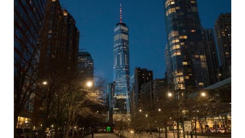 The spire of One World Trade Center in New York glows orange Saturday night.