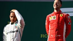 Every picture tells a story.  Sebastian Vettel celebrates on the podium as  second-placed Lewis Hamilton shows his feelings.