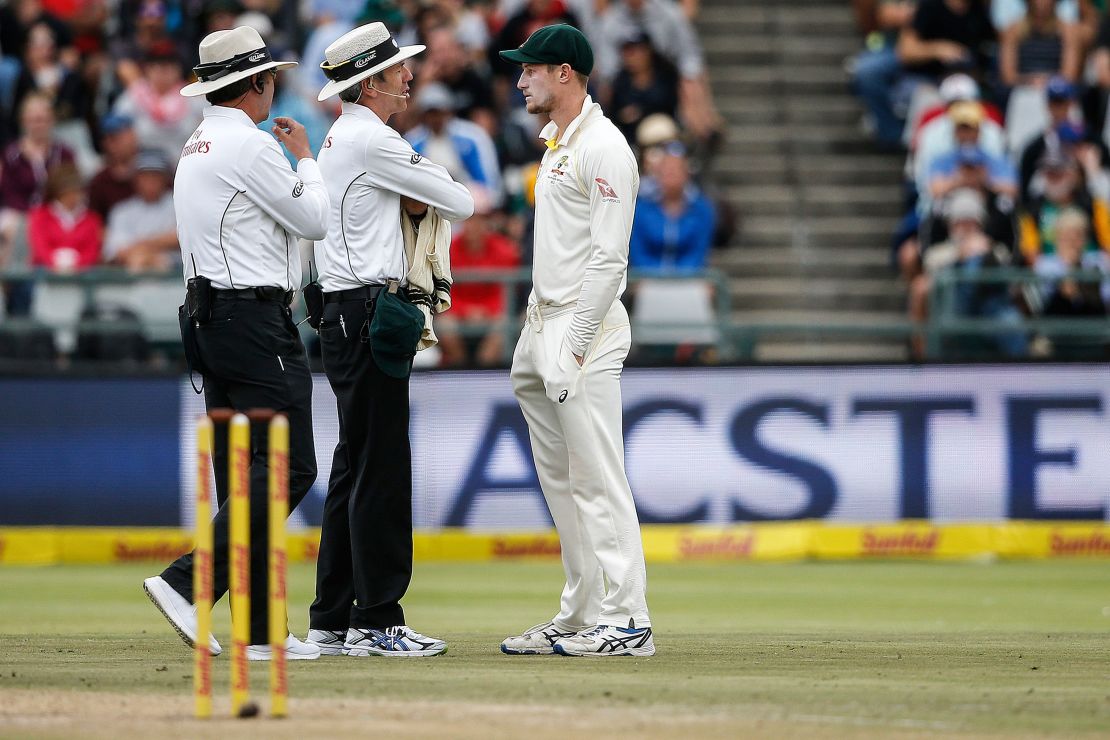 Bancroft (R) is questioned by Umpires Richard Illingworth (L) and Nigel Llong (C) during the third day of the third Test cricket match against South Africa 