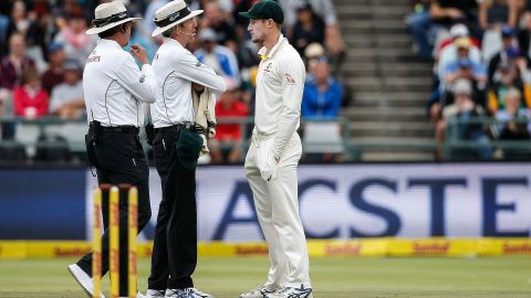 Bancroft (R) is questioned by Umpires Richard Illingworth (L) and Nigel Llong (C) during the third day of the third Test cricket match against South Africa 