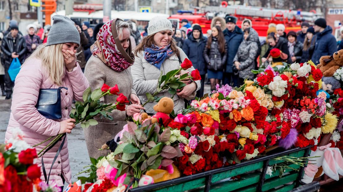People lay flowers for the victims of a fire in a multi-story shopping center in the Siberian city of Kemerovo, about 3,000 kilometers (1,900 miles) east of Moscow, Russia, Monday, March 26, 2018. 