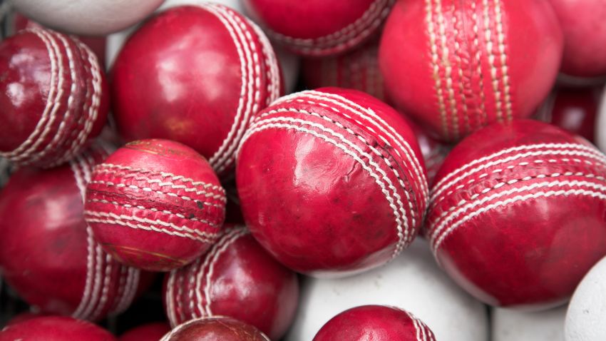 old, red cricket balls