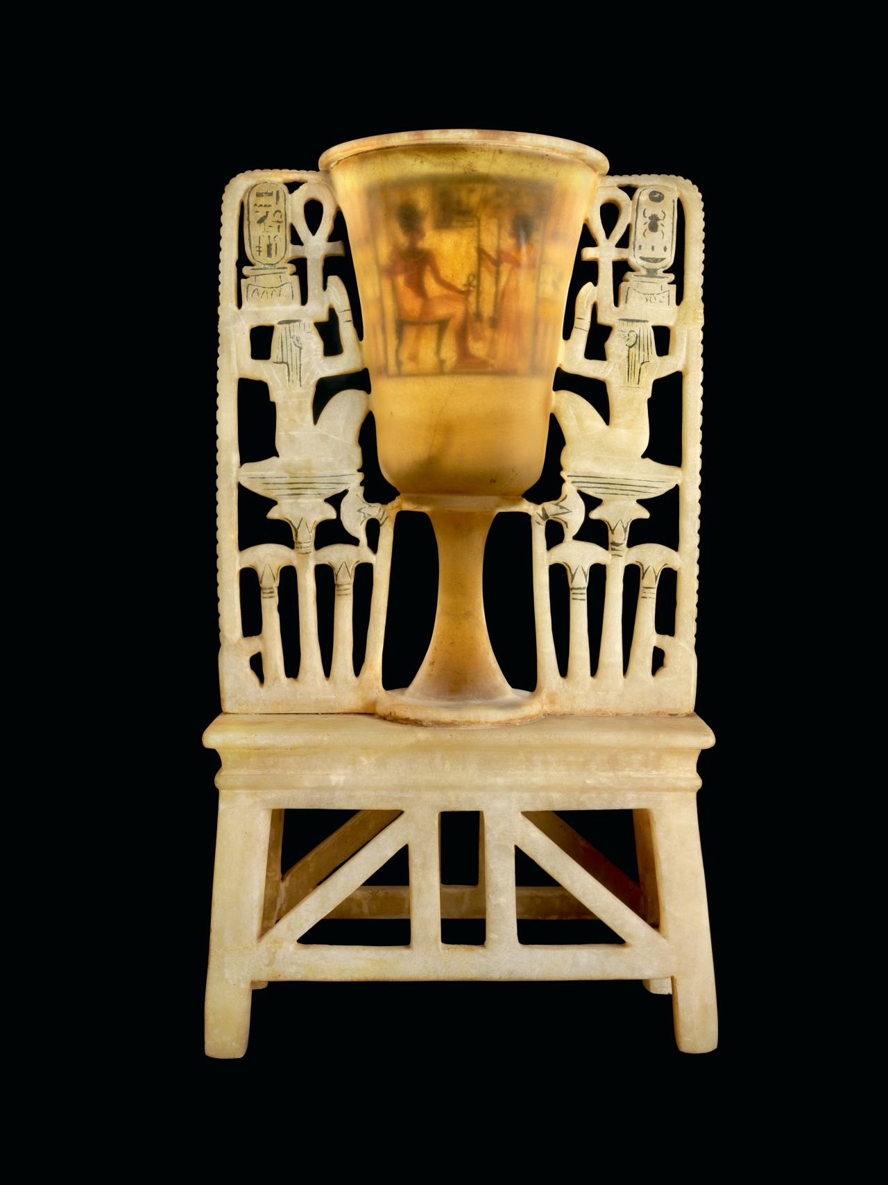 This lamp takes the form of a tall lotus-shaped globet attached to a stand.