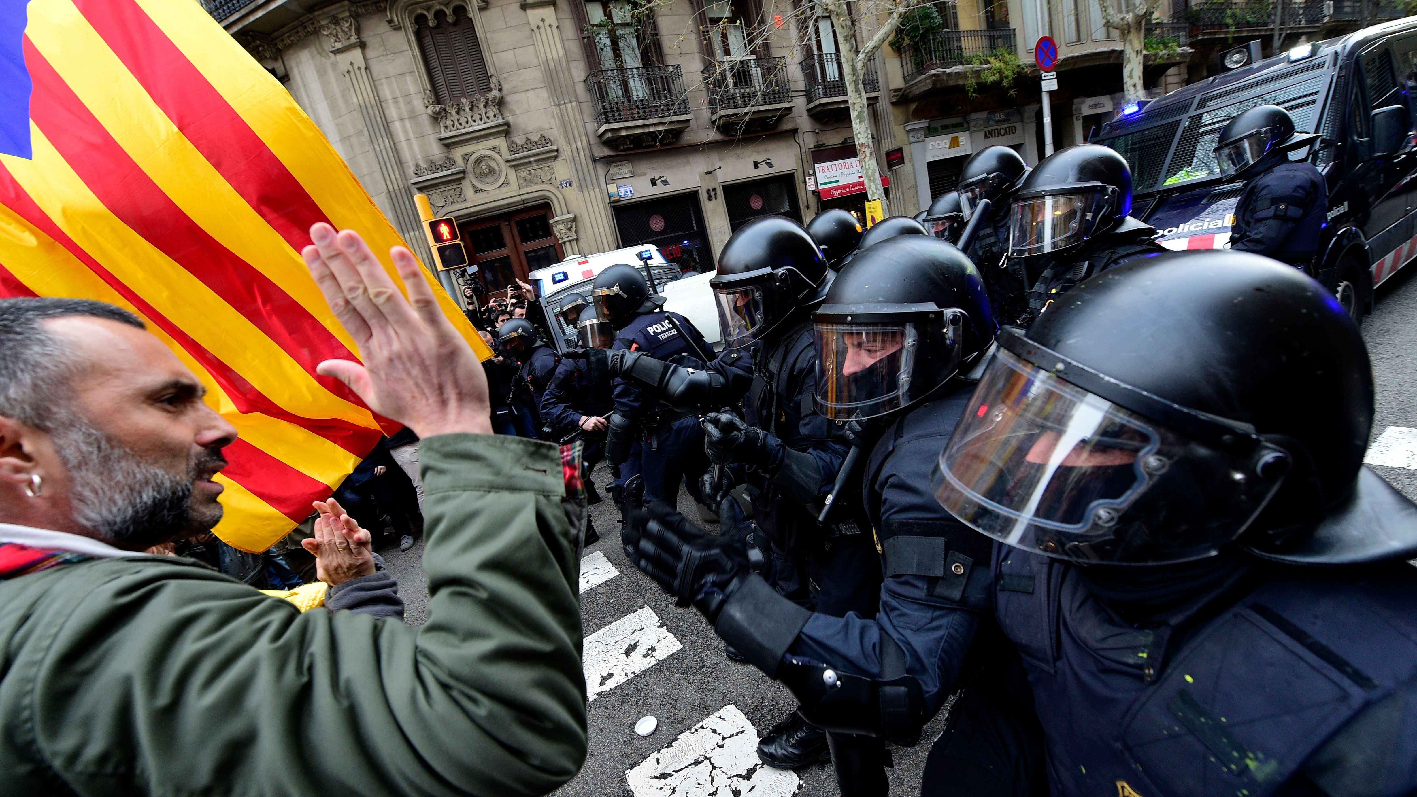 Protesters scuffle with riot police at a demonstration in Barcelona on March 25, 2018.