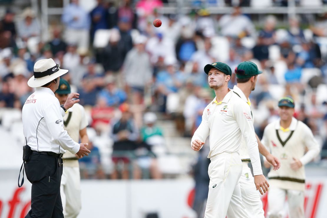 Cameron Bancroft (right) throws the ball to umpire Richard Illingworth.