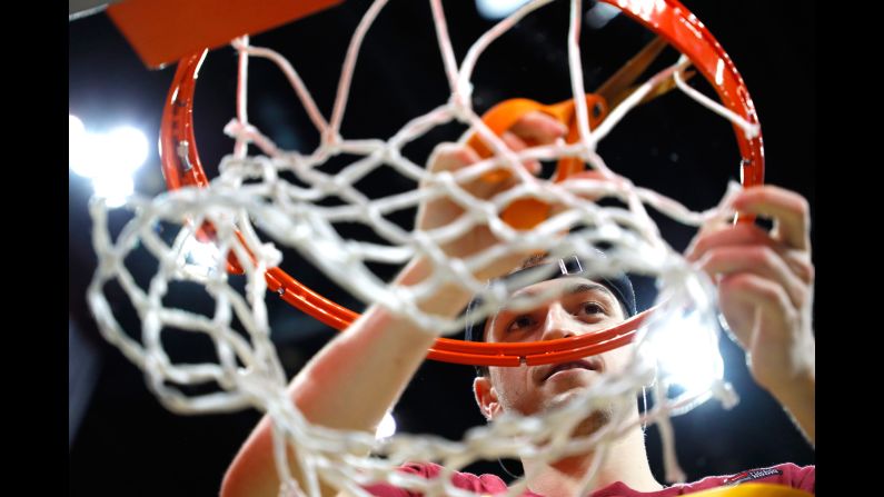 Loyola guard Clayton Custer cuts down the net on Saturday, March 24, after the Chicago university -- a No. 11 seed -- defeated Kansas State to clinch an unlikely spot in the Final Four.