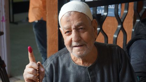 An elderly voter shows his ink-stained finger after voting in Cairo's Gamalya, the neighborhood where Sisi was born.