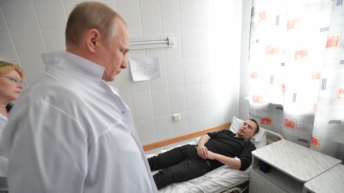 Vladimir Putin visits people injured in the fire.