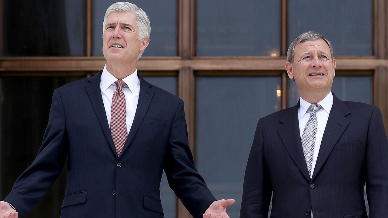 Supreme Court Justice Neil Gorsuch (L) talks with Chief Justice John Roberts (R) on the steps of the Supreme Court following his official investiture at the Supreme Court June 15, 2017 in Washington, DC.  (Photo by Win McNamee/Getty Images)