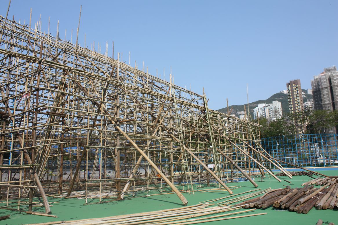 One week into construction the bamboo theater is taking shape. The wooden pillars seen here, placed at an angle, add stability during the building process. 