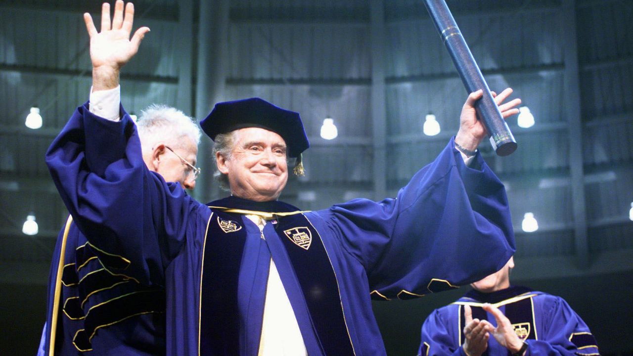 Regis Philbin, a Notre Dame graduate, waves to the crowd after receiving an honorary degree during Notre Dame's 154th commencement exercises in South Bend, Indiana, on May 16, 1999.
