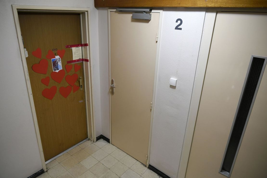 A photo taken on Tuesday shows an image of Mireille Knoll, heart-shaped cutouts, and police seals on the door of Knoll's apartment. 