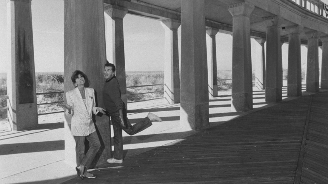 TV talk show cohosts Regis Philbin and Kathie Lee Gifford clown around on an empty section of the boardwalk at Atlantic City.  