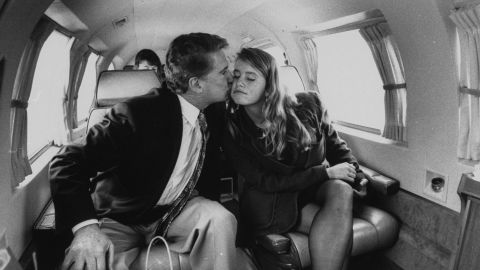 Regis Philbin gives his daughter J.J. a kiss on an airplane en route to Notre Dame University.