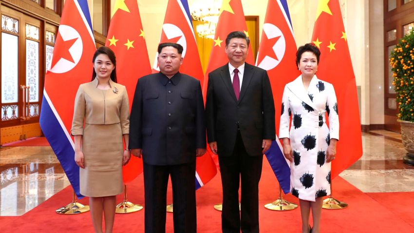 In this photo released Wednesday, March 28, 2018 by China's Xinhua News Agency, Chinese President Xi Jinping, second from right, and his wife Peng Liyuan, right, and North Korean leader Kim Jong Un, second from left, and his wife Ri Sol Ju, left, pose for a photo at the Great Hall of the People in Beijing. The Chinese government confirmed Wednesday that North Korea's reclusive leader Kim went to Beijing and met with Chinese President Xi in his first known trip to a foreign country since he took power in 2011. (Ju Peng/Xinhua via AP)