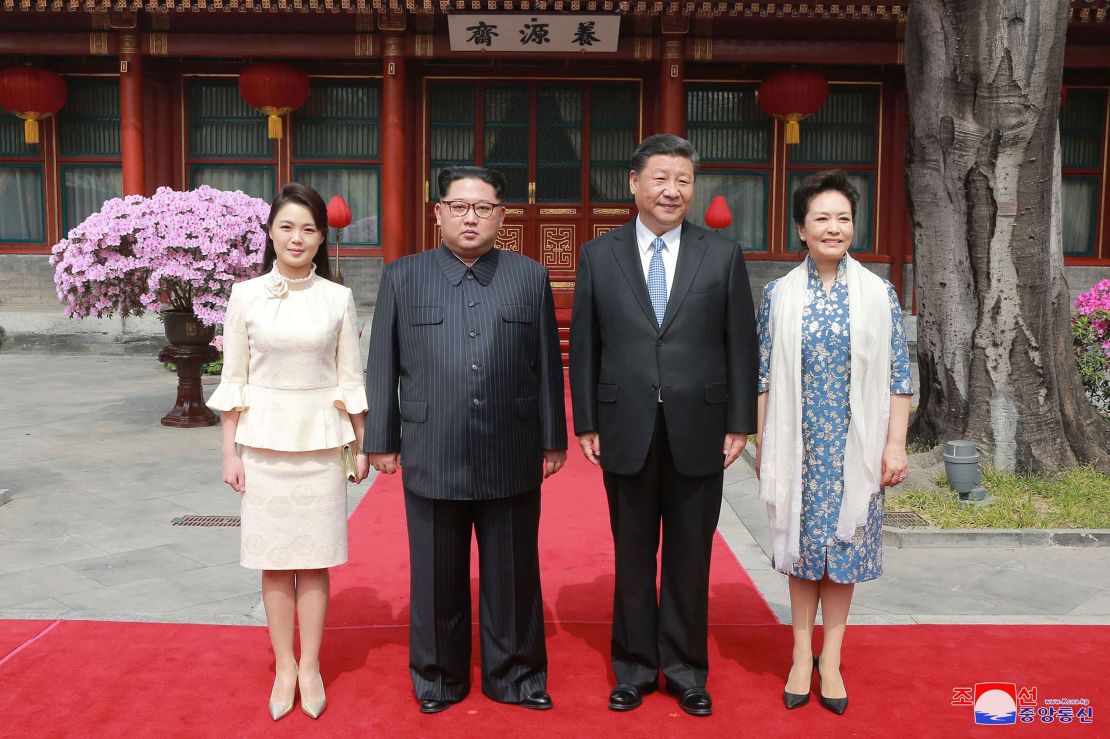 North Korean leader Kim Jong Un, his wife Ri Sol Ju, Xi Jinping and his wife Peng Liyuan pose for a photo at Diaoyutai State Guesthouse in Beijing.