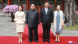 In this March 27, 2018, photo, North Korean leader Kim Jong Un, center left, and his wife Ri Sol Ju, left, Chinese counterpart Xi Jinping, center right, and his wife Peng Liyuan pose for a photo at Diaoyutai State Guesthouse in Beijing. North Korea's leader Kim Jong Un and his Chinese counterpart Xi Jinping sought to portray strong ties between the long-time allies despite a recent chill as both countries on Wednesday, March 28, 2018,  confirmed Kim's secret trip to Beijing this week.  The content of this image is as provided and cannot be independently verified. Korean language watermark on image as provided by source reads: "KCNA" which is the abbreviation for Korean Central News Agency.  (Korean Central News Agency/Korea News Service via AP)