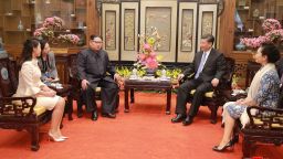 In this March 27, 2018, photo, North Korean leader Kim Jong Un, center left, and his wife Ri Sol Ju, left, talk with Chinese counterpart Xi Jinping, second from right, and his wife Peng Liyuan at Diaoyutai State Guesthouse in Beijing. North Korea's leader Kim and his Chinese counterpart Xi sought to portray strong ties between the long-time allies despite a recent chill as both countries on Wednesday, March 28, 2018, confirmed Kim's secret trip to Beijing this week. The content of this image is as provided and cannot be independently verified. Korean language watermark on image as provided by source reads: "KCNA" which is the abbreviation for Korean Central News Agency.  (Korean Central News Agency/Korea News Service via AP)