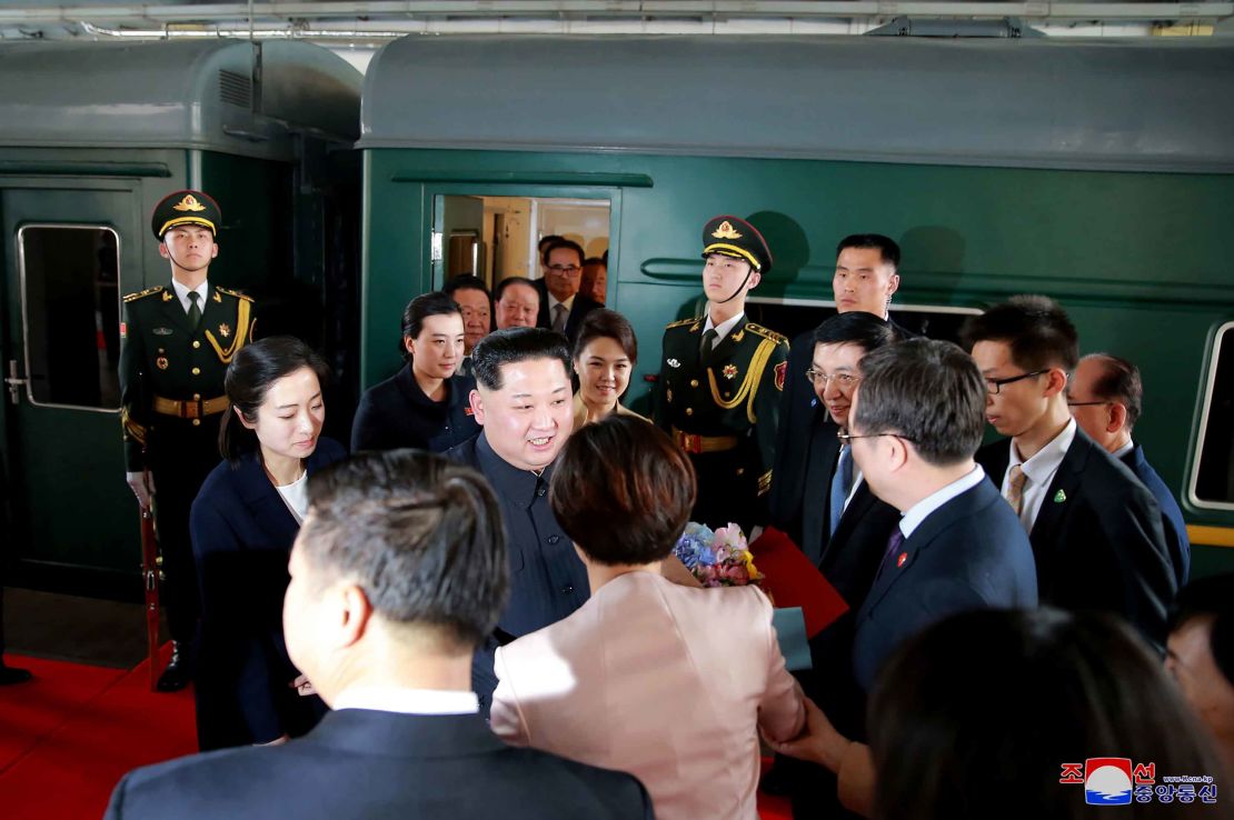 Kim Jong Un, center, and his wife, Ri Sol Ju, center right, are greeted by Chinese officials in Beijing. 