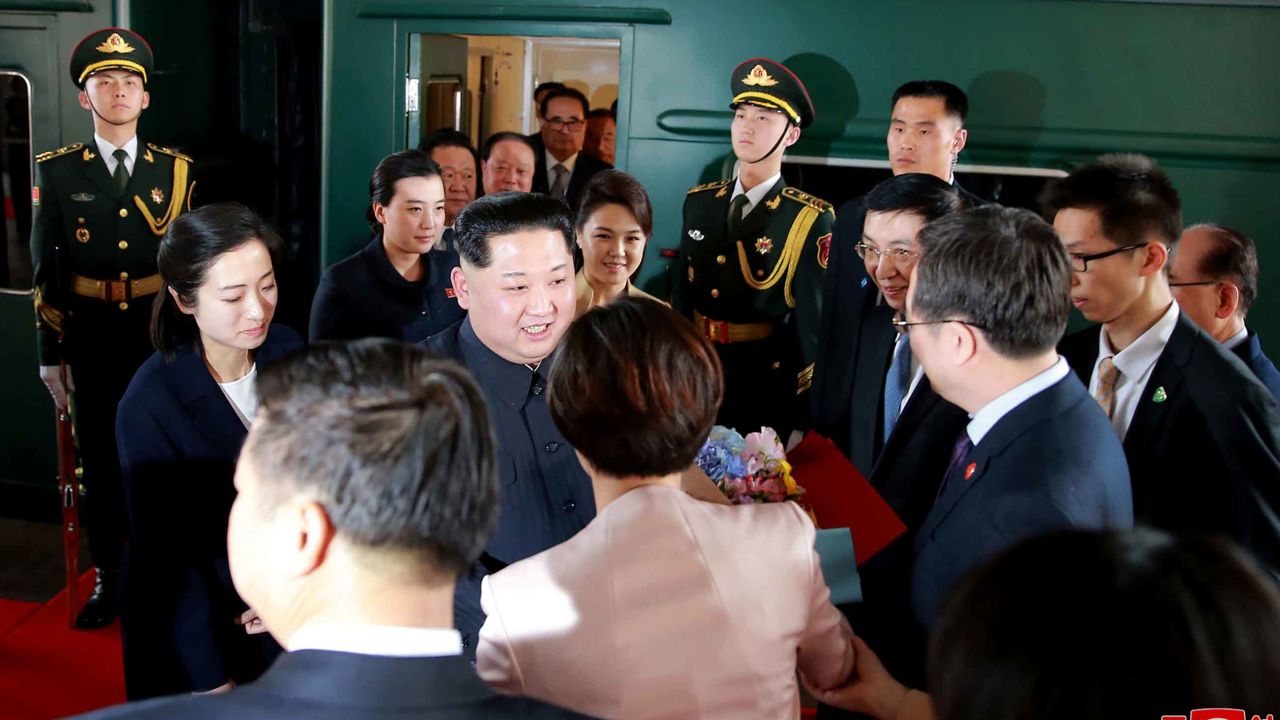 In this March 26, 2018, photo provided March 28, 2018, by the North Korean government, North Korean leader Kim Jong Un, center, and his wife Ri Sol Ju, center right, are greeted by Chinese Communist Party members on the arrival at Beijing station in Beijing. Kim made the unofficial visit to China at Xi's invitation, China's official Xinhua News Agency said, in his first trip to a foreign country since he took power in 2011. Xinhua said the trip ran from Sunday to Wednesday but appeared to include travel time from Pyongyang on the special armored train that Kim traveled in, which secretly arrived in Beijing on Monday and left Tuesday afternoon. The content of this image is as provided and cannot be independently verified. Korean language watermark on image as provided by source reads: "KCNA" which is the abbreviation for Korean Central News Agency. (Korean Central News Agency/Korea News Service via AP)