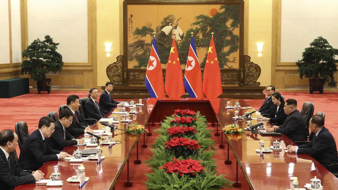 In this photo released Wednesday by China's Xinhua News Agency, Chinese President Xi Jinping, fourth from left, and North Korean leader Kim Jong Un, second from right, meet at the Great Hall of the People in Beijing.