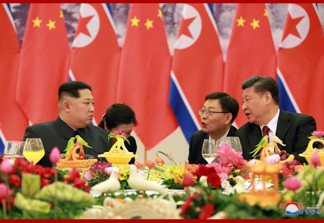 Kim Jong Un, left, and Xi Jinping, right, are seen at a banquet in this photo released by North Korean state media.