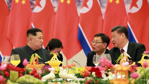 Kim Jong Un, left, and Xi Jinping, right, are seen at a banquet in this photo released by North Korean state media.