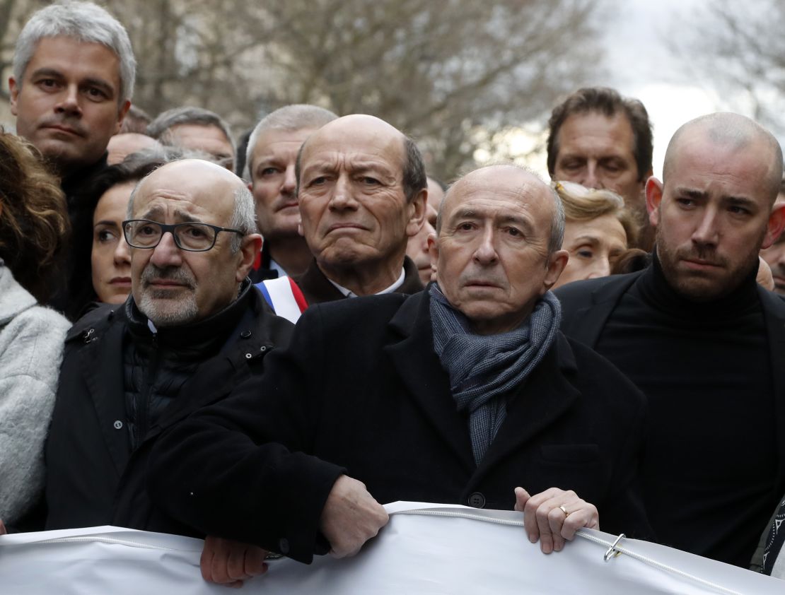 French Interior Minister Gerard Collomb, second right, and other French officials marching in Paris on Wednesday,
