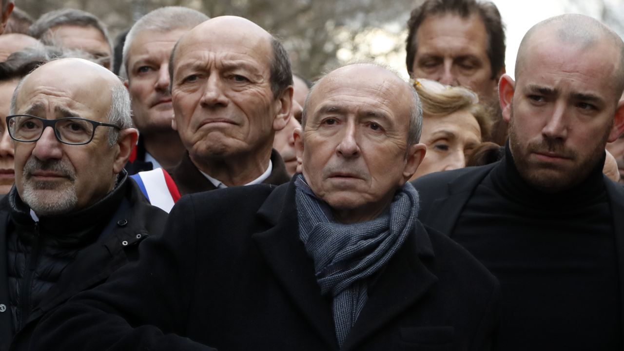 French Interior Minister Gerard Collomb, second right, and other French officials marching in Paris on Wednesday,