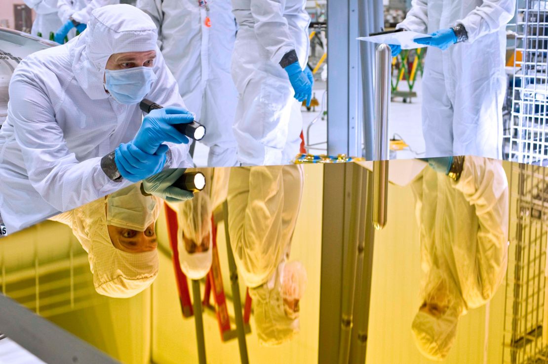 An engineer inspects a segment of Webb's main mirror.