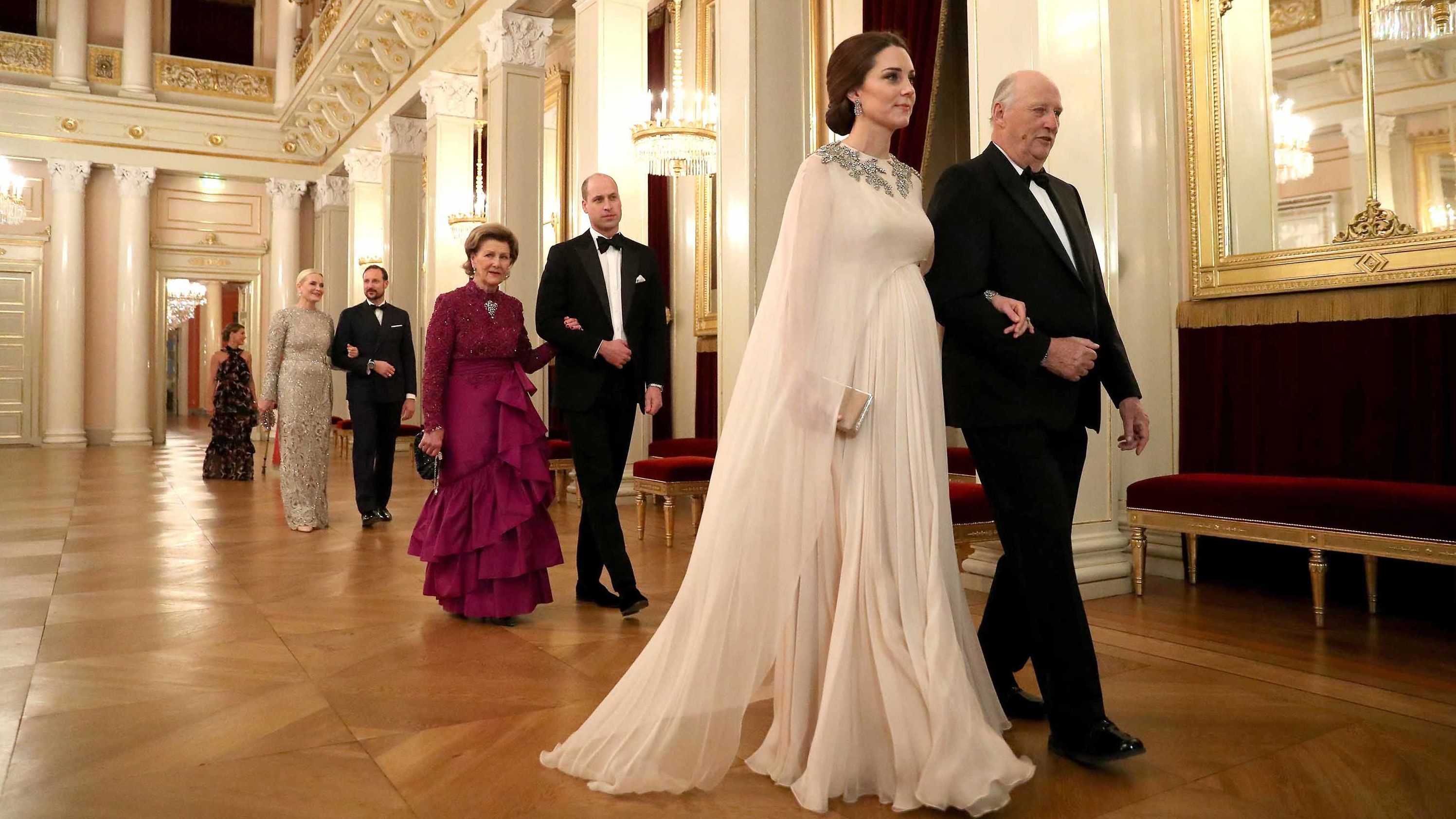 Catherine is escorted to dinner by Norwegian King Harald V during a visit to Norway in February 2018. William is escorted by Norway's Queen Sonja.