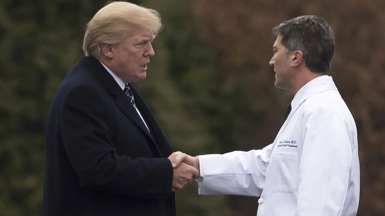 US President Donald Trump shakes hands with White House Physician Rear Admiral Dr. Ronny Jackson, following his annual physical at Walter Reed National Military Medical Center in Bethesda, Maryland, January 12, 2018. / AFP PHOTO / SAUL LOEB        (Photo credit should read SAUL LOEB/AFP/Getty Images)