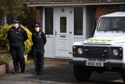British Police community support officers stand on duty outside a house in Salisbury on March 6.