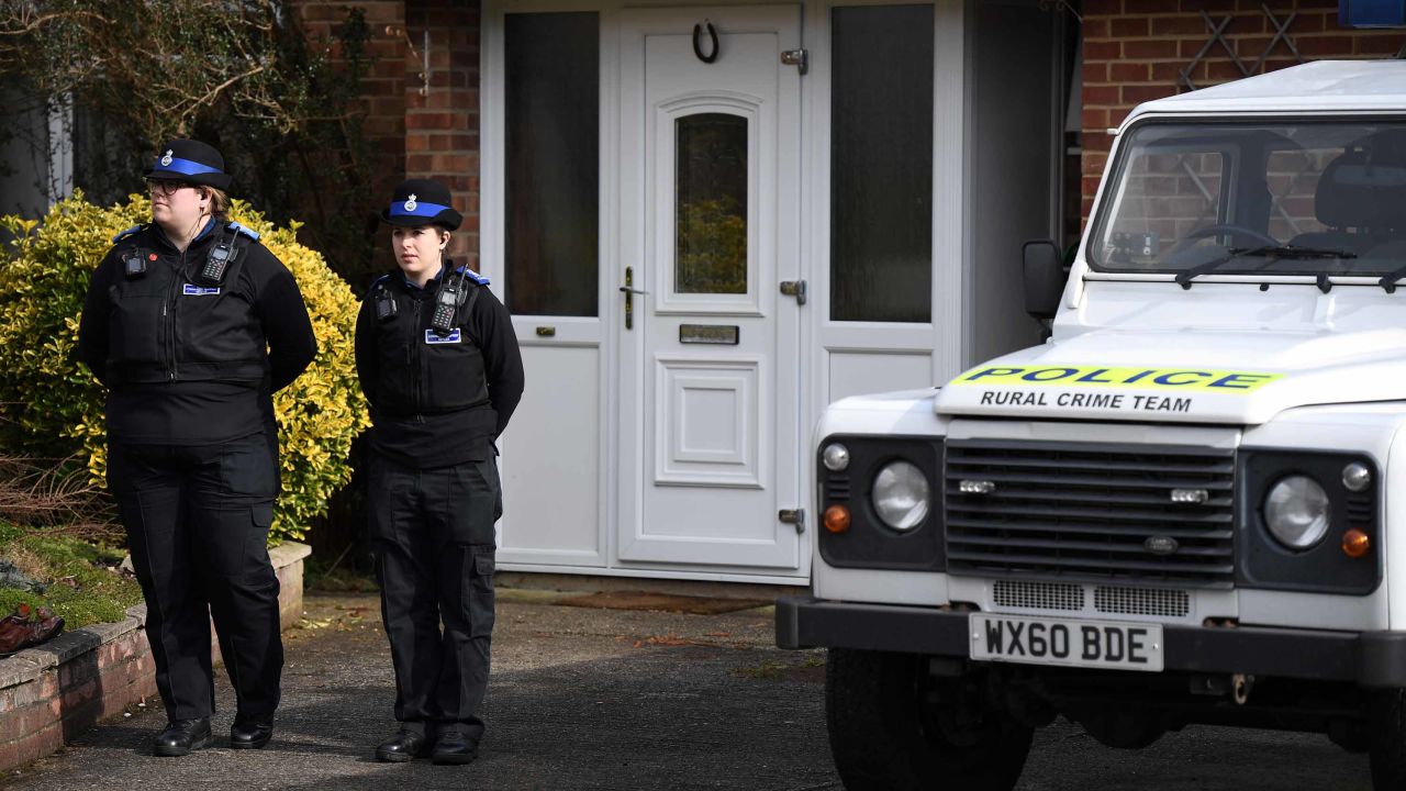 British Police community support officers stand on duty outside a house in Salisbury on March 6.