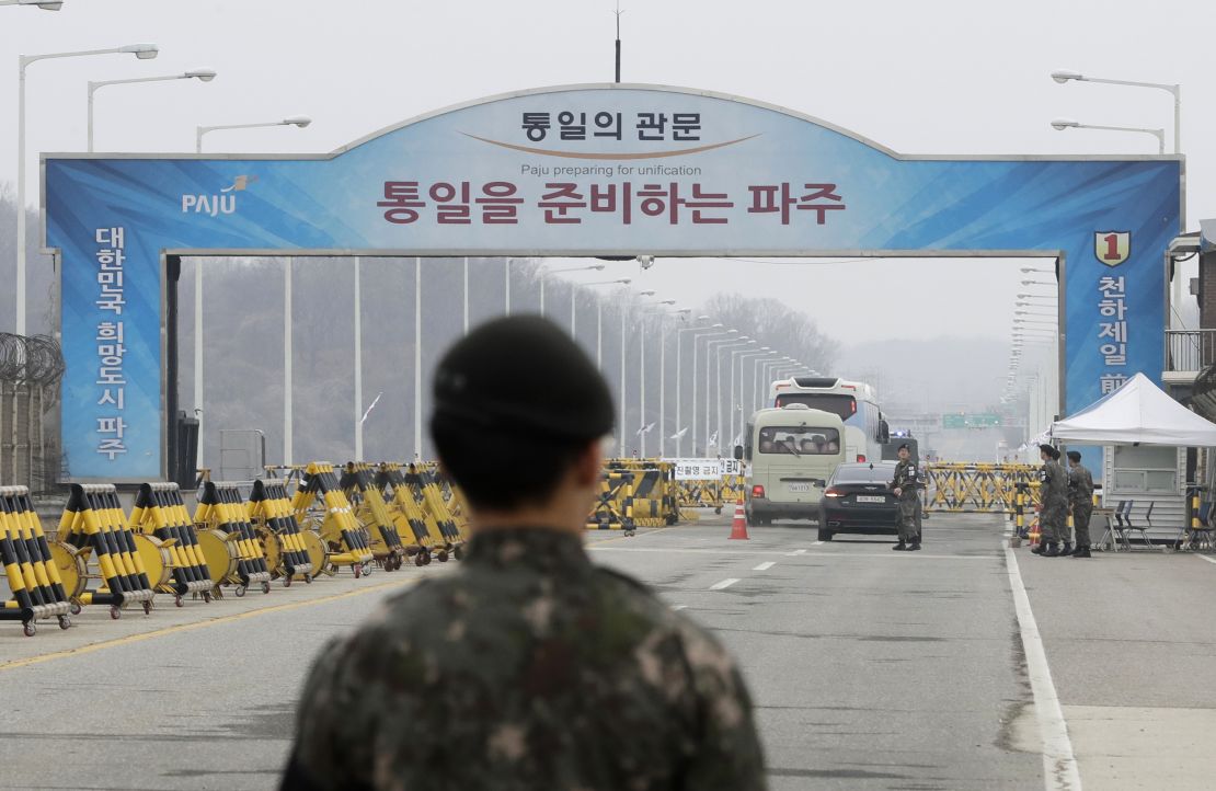 South Korean soldiers stand as vehicles carrying a South Korean delegation pass the Unification Bridge, which leads to the Panmunjom in the Demilitarized Zone, South Korea, Thursday, March 29.