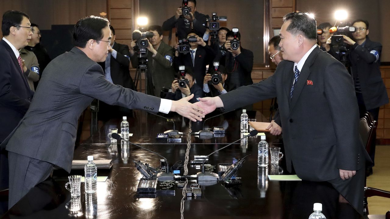 South Korean Unification Minister Cho Myoung-gyon, left, shakes hands with North Korean delegation head Ri Son Gwon at Panmunjom on March 29.