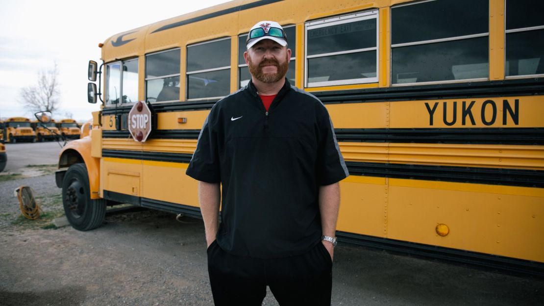 Math teacher Jonathan Moy also drives a school bus, his second job of the day. Afterward, he'll umpire two baseball games.