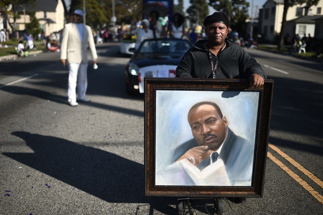 Artist Al Hornsby marches with a portrait of King during the Kingdom Day Parade in Los Angeles in 2015.