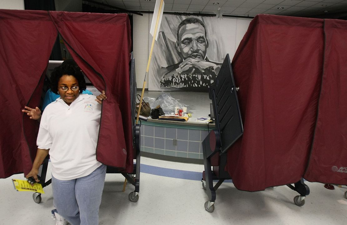 A woman whose home was destroyed during Hurricane Katrina exits a voting booth after casting her ballot.