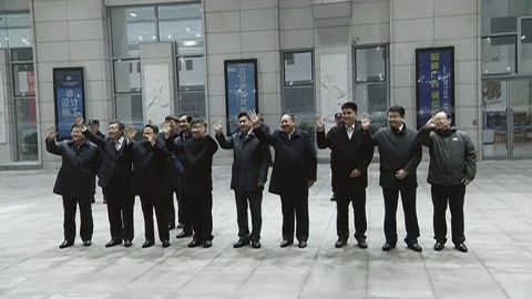 Chinese officials wave goodbye as Kim's train departs Dandong.