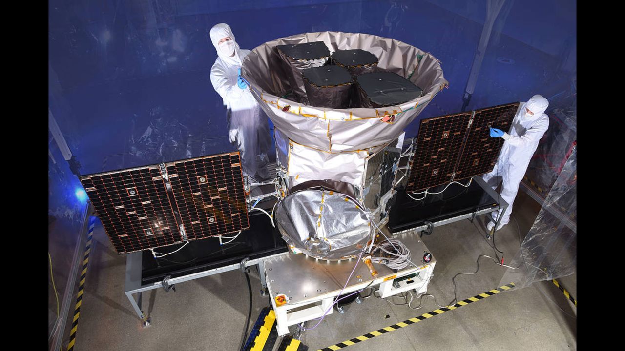 Technicians help prepare the spacecraft for its mission.
