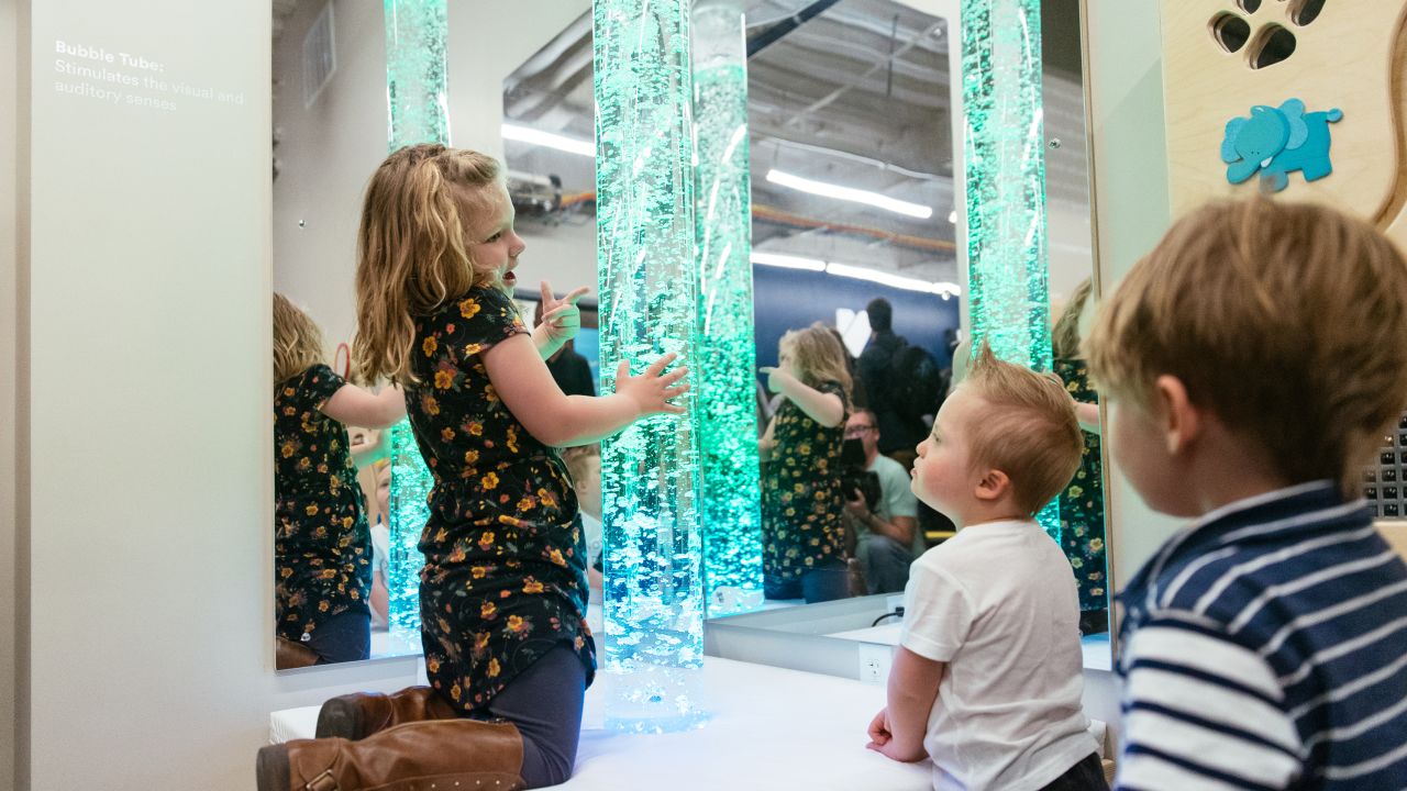 Children play with bubble tubes in the new sensory room.
