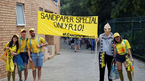 South Africa fans hold a banner as they mock Australia's cricket players during day one of the fourth Test