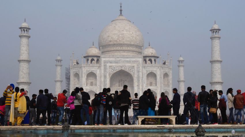 Crowds gather to visit the Taj Mahal in Agra on January 3, 2018. 
India is to restrict the number of daily visitors to the Taj Mahal in an effort to preserve the iconic 17th-century monument to love, its biggest tourist draw. Millions of mostly Indian tourists visit the Taj Mahal every year and their numbers are increasing steadily as domestic travel becomes more accessible.
 / AFP PHOTO / DOMINIQUE FAGET        (Photo credit should read DOMINIQUE FAGET/AFP/Getty Images)